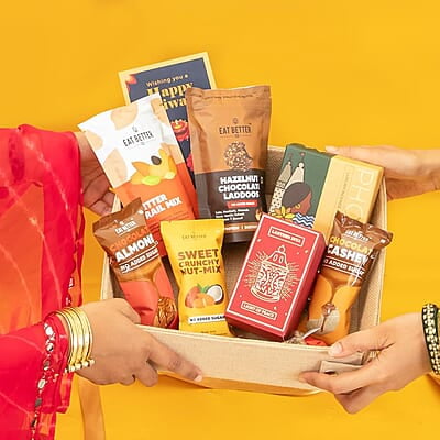 Eat Better Co Prakriti Diwali Gift Hamper with Jute Tray - 10 Item Gift Pack - Dry Fruits Laddoo, Chocolate Coated Nuts with Phool Incense Cones & Lanten Diya | Diwali Gift Box for Friends & Family Eat Better Co Prakriti Diwali Gift Hamper with Jute Tray - 10 Item Gift Pack - Dry Fruits Laddoo, Chocolate Coated Nuts with Phool Incense Cones & Lanten Diya | Diwali Gift Box for Friends & Family